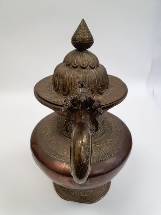 Late 19th century or later, Tibetan copper and brass fitted teapot, with Naga form handle. - Image 25 of 33