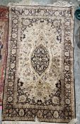Five small silk rugs to include a cream ground rug with central oval floral medallion surrounded