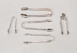 Five assorted sugar tongs to include Edward VII sugar tongs with bright cut decoration, London