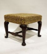 Early Georgian-style oak footstool with upholstered seat above carved oak support, on pad feet,