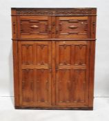 20th century oak cupboard with carved decoration above moulded panelled cupboard doors, on plinth