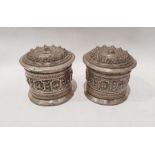 Pair of Burmese silver coloured metal lidded containers of cylindrical form with bull decoration,