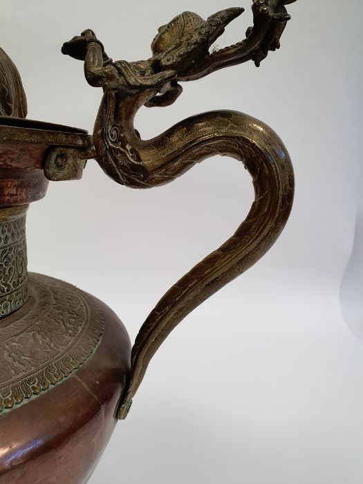 Late 19th century or later, Tibetan copper and brass fitted teapot, with Naga form handle. - Image 20 of 33