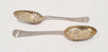 Two George II silver berry spoons, cut and embossed decoration and one further similar, London 1759,