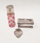 Silver postage stamp holder with two glass inset panels to the hinged lid, on a barrel-shaped