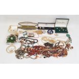 Large quantity of beaded necklaces, powder press boxes, assorted brooches, some gold-coloured ladies