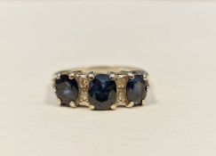 18ct white gold, sapphire and diamond ring set three oval sapphires flanked by two pairs of small
