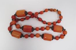 Amber-style long bead necklace of cylindrical and oval beads