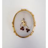 Agate, gold-coloured metal and garnet brooch, oval with floral spray