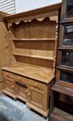 20th century pine dresser with moulded cornice above open shelves, the base of three drawers and