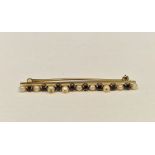 Gold, sapphire and pearl bar brooch set multiple claw set stones and small pearls