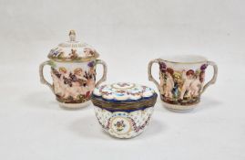 Pair Capodimonte porcelain covered two-handled chocolate cups, relief decorated with Bacchanalian