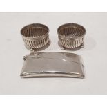 Pair of Victorian silver salts with reeded decoration, raised on three ball feet and a silver card