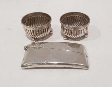 Pair of Victorian silver salts with reeded decoration, raised on three ball feet and a silver card