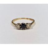 9ct gold, sapphire and diamond ring set oval sapphire flanked by two illusion set diamonds