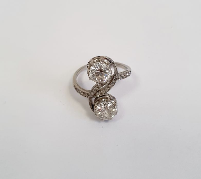 Diamond two-stone crossover ring, each diamond approx. 0.7ct and on scroll crossover branch inset