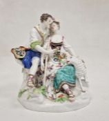 19th century Meissen porcelain figure group of shepherd and shepherdess seated on rocky mound, the