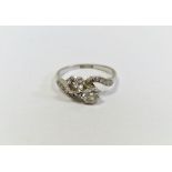 Platinum and diamond crossover ring set two claw-set diamonds with small diamonds to the