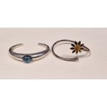Baccarat silver and blue stone set cuff bangle and an Andrew Scott silver 'Lazy Daisy' bangle with