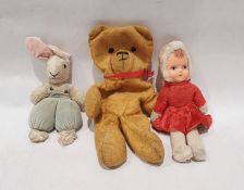 Mid 20th Century soft toys to include - doll with vinyl face, bear with red ribbon and with stuffing