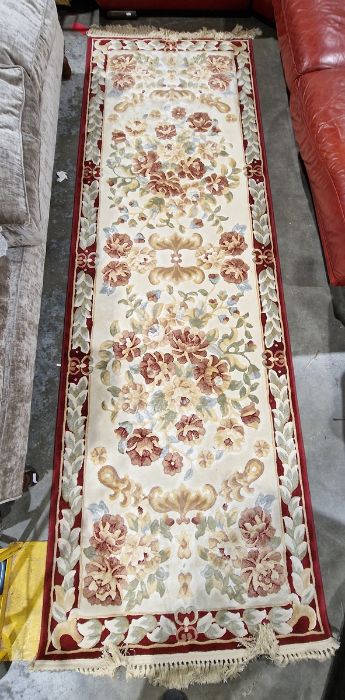 Large cream ground runner with several floral medallions flanked by floral border 304cm X 99cm