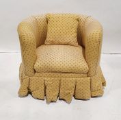 Child's yellow pattern upholstered tub chair on metal castors.