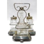 Electroplated cruet set on stand with quatrefoil base, glass and electroplated condiments, all
