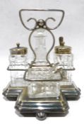 Electroplated cruet set on stand with quatrefoil base, glass and electroplated condiments, all