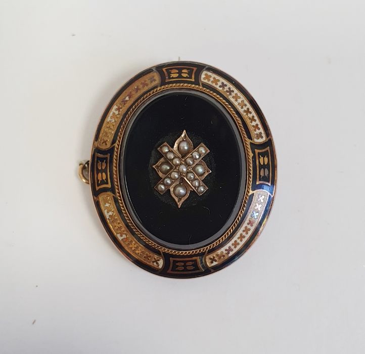 Victorian gold-coloured metal, black onyx, enamel and seedpearl mourning brooch, oval set with