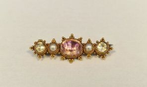 Antique gold-coloured metal, pearl, pink and white stone set brooch, the oval pink stone flanked