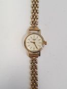 Lady's 9ct gold Longines wristwatch with baton numerals and side button and the 9ct gold chain