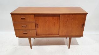 Mid century modern teak sideboard with three drawers, two sliding cupboard doors, on cylindrical