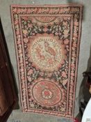 Eastern style black ground rug with two medallions on with bird and floral decoration and the