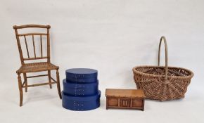 Doll's bamboo and cane chair, a wicker basket, a dolls-style oak coffer and a set of graduated