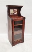 19th century mahogany mirrored back cabinet with single glazed door enclosing shelves, to plinth,