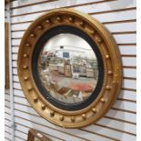 Victorian-style circular convex mirror with bull decoration to the moulded frame, 60cm diameter