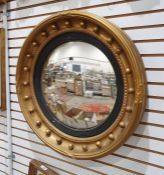 Victorian-style circular convex mirror with bull decoration to the moulded frame, 60cm diameter