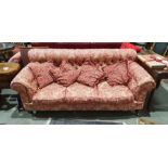 Victorian button-back Chesterfield three-seater settee in pink floral brocade and on turned bun feet