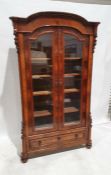 19th century continental glazed mahogany cabinet, the moulded cornice above domed top, the two