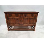 20th century oak sideboard with two drawers above two linenfold decorated cupboard doors, on