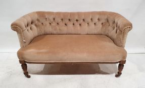 Edwardian two-seat settee with button-back upholstery, on turned front legs to brown china castors