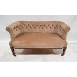 Edwardian two-seat settee with button-back upholstery, on turned front legs to brown china castors