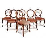Set of six Victorian walnut balloonback chairs with carved top rail, circular back, serpentine