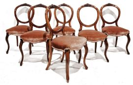 Set of six Victorian walnut balloonback chairs with carved top rail, circular back, serpentine