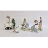 Nao figure of girl seated with doves, another girl with kitten, two other Nao girl figures and a