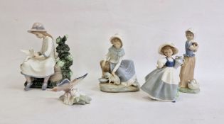 Nao figure of girl seated with doves, another girl with kitten, two other Nao girl figures and a