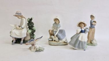 Nao figure of girl seated with doves, another girl with kitten, two other Nao girl figures and a