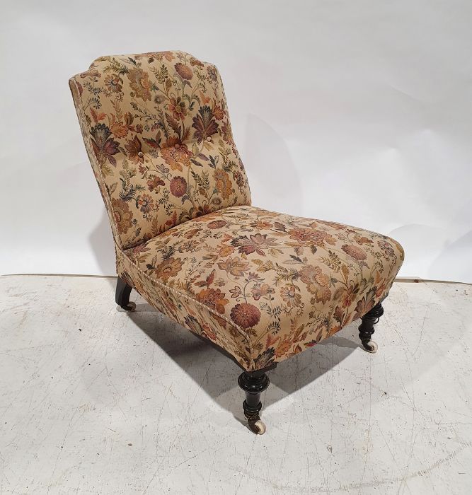 Early Victorian low nursing chair with upholstered seat and back, ebonised and turned front legs