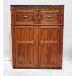 20th century oak cupboard with carved decoration above moulded panelled cupboard doors, on plinth