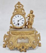 Gold painted brass and alabaster timepiece with foliate detailing and blacksmith figure to the right